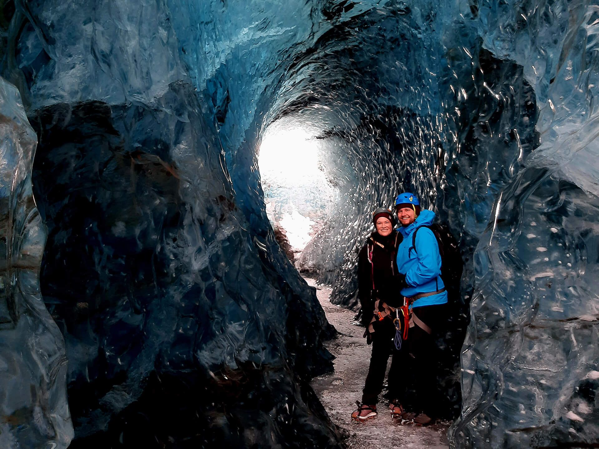 Ice cave explorers in a meltwater tunnel on an Icelandic glacier outlet of Vatnajökull Ice Cap
